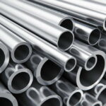 Creative abstract heavy metallurgical industry and industrial manufacturing business production concept: heap of shiny metal steel pipes with selective focus effect